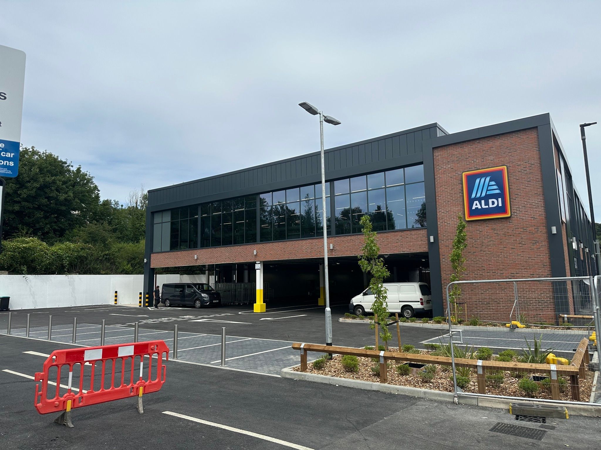 Aldi Caterham exterior car park by retaining railway wall