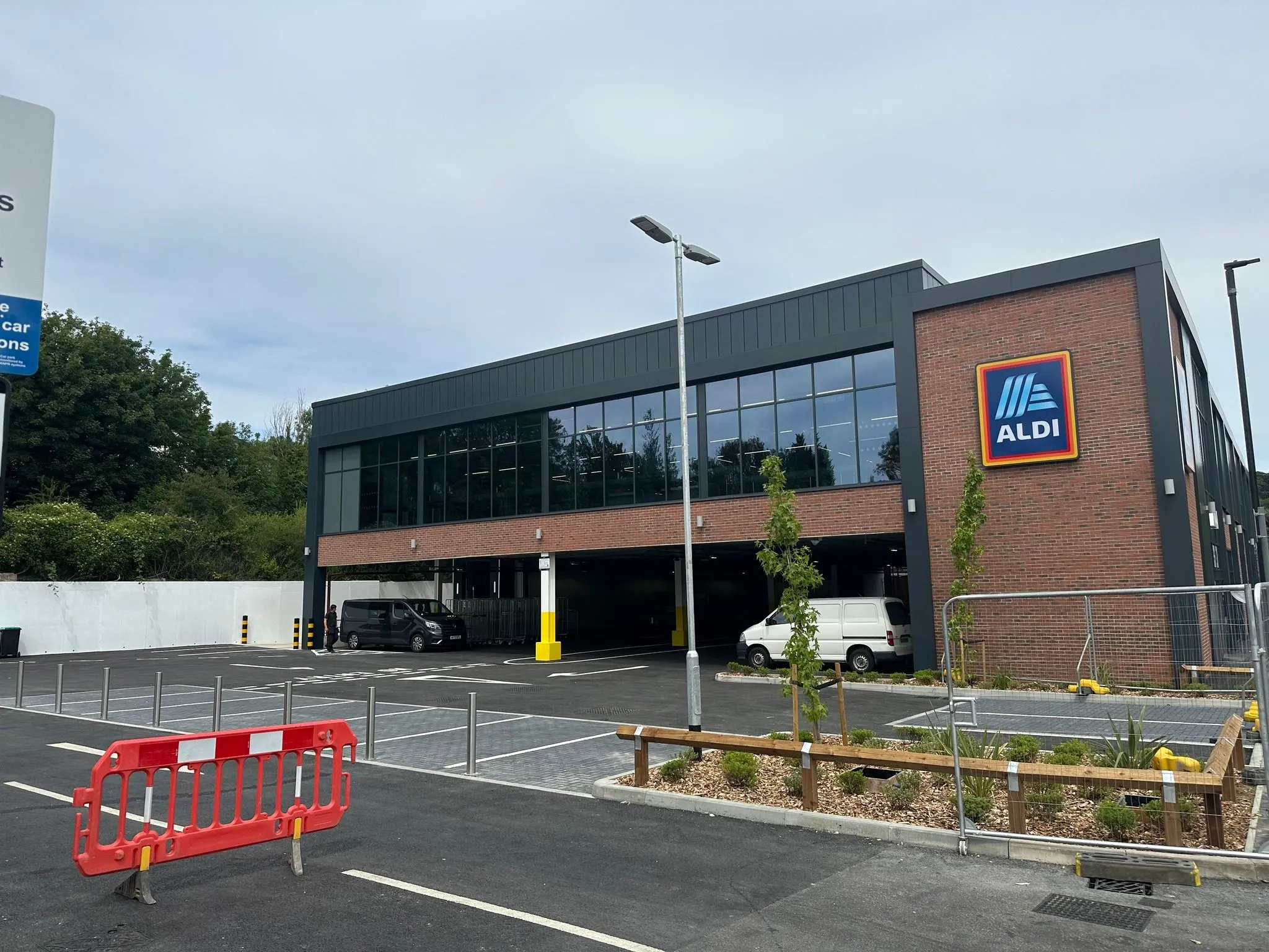 Aldi Caterham exterior car park by retaining railway wall