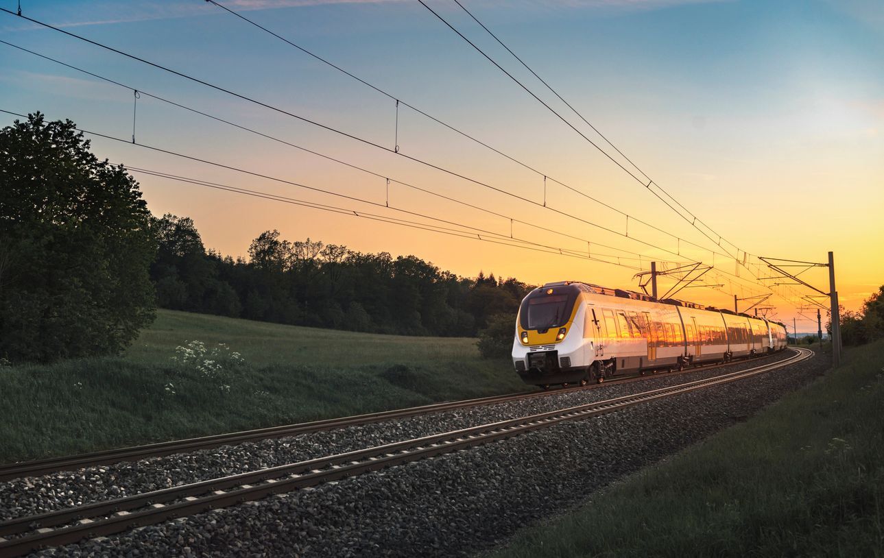 Train on tracks with sunset