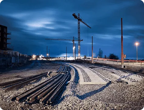 Trains and cranes at night