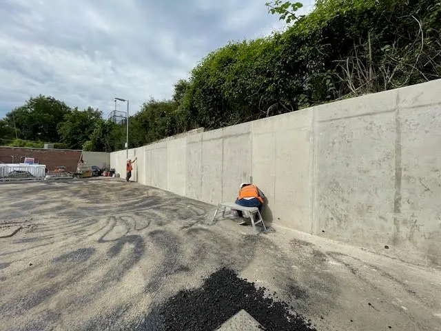 New retaining wall being built by railway for new Aldi store at Caterham