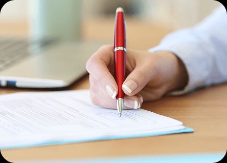 person writing with pen on paper